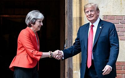 US President Donald Trump (R) and Britain's Prime Minister Theresa May (L) shake hands upon Trump's arrival for a meeting at Chequers, the prime minister's country residence, near Ellesborough, northwest of London, on July 13, 2018. (AFP Photo/Pool/Jack Taylor)