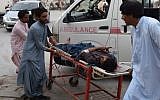 A victim of a bomb blast is brought to a hospital in Quetta on July 13, 2018 following an attack at an election rally. (AFP/Banaras Khan)