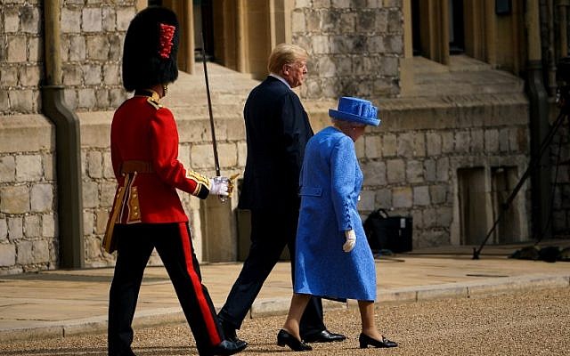 Britain's Queen Elizabeth II and US President Donald Trump walk to inspect the Guard of Honour at Windsor Castle in Windsor, west of London, on July 13, 2018 on the second day of Trump's UK visit. (AFP PHOTO / Brendan Smialowski)