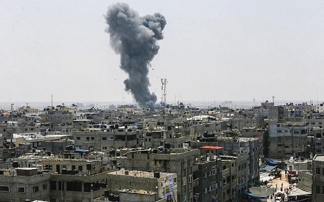 A picture taken on July 14, 2018, shows a smoke plume rising following an Israeli air strike in the southern Gaza Strip city of Rafah, near the border with Egypt (AFP PHOTO / SAID KHATIB) A picture taken on July 14, 2018, shows a smoke plume rising following an Israeli air strike in the southern Gaza Strip city of Rafah, near the border with Egypt (AFP PHOTO / SAID KHATIB)