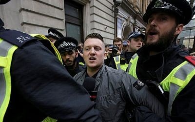 In this file photo taken on April 01, 2017 Stephen Christopher Yaxley-Lennon, AKA Tommy Robinson, former leader of the right-wing EDL (English Defence League) is escorted away by police from a Britain First march and an English Defence League march in central London (AFP PHOTO / Daniel LEAL-OLIVAS)