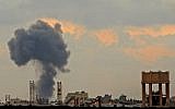 A picture taken on July 20, 2018, from across the border with the Gaza strip near the southern Israeli Kibbutz of Nahal Oz, shows a smoke plume rising from an explosion during Israeli bombardment in Gaza City. (AFP PHOTO / JACK GUEZ)