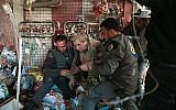 Syrian Civil Defense volunteers, known as the White Helmets, rescue a survivor following reported air-strikes on the rebel-held town of Hamouria, in Eastern Ghouta outside Syria's capital Damascus, March 25, 2017. (AFP Photo/Msallam Abdalbaset/File)