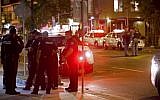 Toronto Police officers walk the scene at Danforth St. at the scene of a shooting in Toronto, Ontario, Canada on July 23, 2018. (AFP /Cole BURSTON)