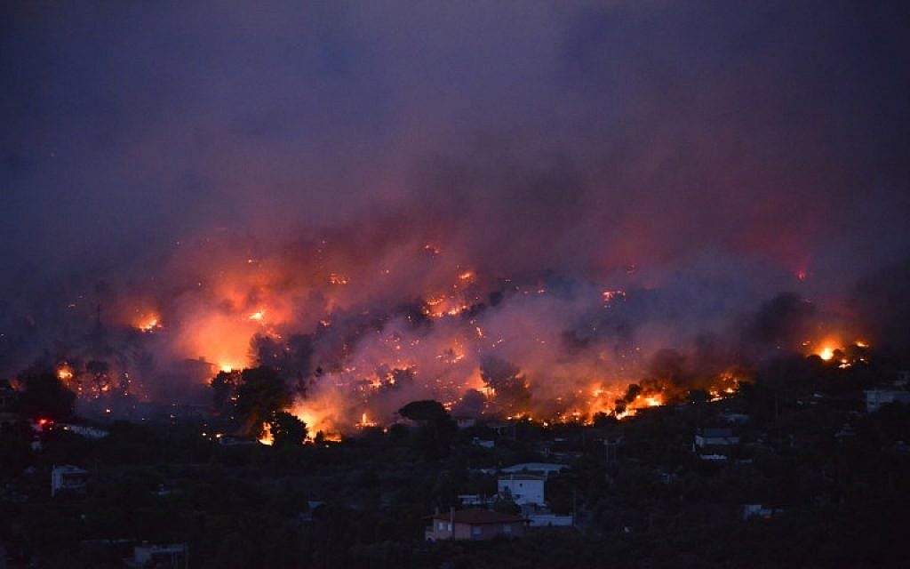 Flames rise as a wildfire burns in the town of Rafina, near Athens, on July 23, 2018. (AFP PHOTO/ANGELOS TZORTZINIS)