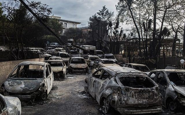 Burnt cars following a wildfire at the village of Mati, near Athens, on July 24, 2018. (AFP PHOTO/ANGELOS TZORTZINIS) Burnt cars following a wildfire at the village of Mati, near Athens, on July 24, 2018. (AFP PHOTO/ANGELOS TZORTZINIS)