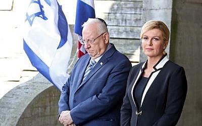 Israeli President Reuven Rivlin, left, and Croatian President Kolinda Grabar Kitarovic pay a tribute at the memorial in the shape of a flower for the victims killed at the Jasenovac concentration camp which was dismantled 73 years ago in Jasenovac, on July 25, 2018.  (AFP/STRINGER)