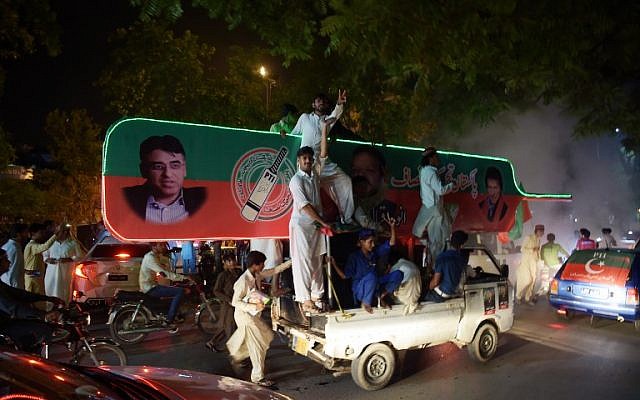 Supporters of Pakistan's cricketer-turned politician Imran Khan, head of the Pakistan Tehreek-e-Insaf (Movement for Justice) party, celebrate on a street during general election in Islamabad on July 25, 2018. (AFP/AAMIR QURESHI) Supporters of Pakistan's cricketer-turned politician Imran Khan, head of the Pakistan Tehreek-e-Insaf (Movement for Justice) party, celebrate on a street during general election in Islamabad on July 25, 2018. (AFP/AAMIR QURESHI)