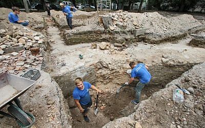 Members of an international team of archaeologists work to unearth parts of the Great Synagogue of Vilnius on July 25, 2018. (AFP Photo/Petras Malukas)