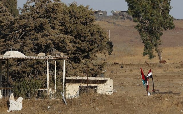 A picture taken on July 26, 2018, near Kibbutz Ein Zivan in the Israeli Golan Heights, shows Syrian national flags (R) and the Baath party flag (L) flying across the border as regime forces retake the area from rebels. (AFP Photo/Jack Guez) A picture taken on July 26, 2018, near Kibbutz Ein Zivan in the Israeli Golan Heights, shows Syrian national flags (R) and the Baath party flag (L) flying across the border as regime forces retake the area from rebels. (AFP Photo/Jack Guez)