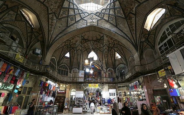 Iranians walk inside Tehran's ancient Grand Bazaar in Tehran on July 28, 2018. (AFP/ATTA KENARE)