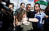 Ahed Tamimi embraces her mother after her release from prison after an eight-month sentence for slapping two Israeli soldiers, in the West Bank village of Nabi Saleh on July 29, 2018. (AFP / ABBAS MOMANI)