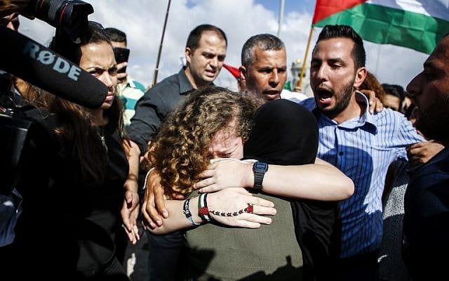 Ahed Tamimi embraces her mother after her release from prison after an eight-month sentence for slapping two Israeli soldiers, in the West Bank village of Nabi Saleh on July 29, 2018. (AFP / ABBAS MOMANI) Ahed Tamimi embraces her mother after her release from prison after an eight-month sentence for slapping two Israeli soldiers, in the West Bank village of Nabi Saleh on July 29, 2018. (AFP / ABBAS MOMANI)