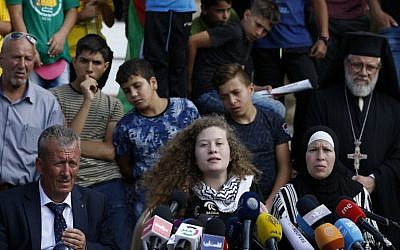 Palestinian activist Ahed Tamimi (C) speaks, as she sits between her father Bassem (C-L) and mother Nariman (C-R), during a press conference in the West Bank village of Nabi Saleh on July 29, 2018 (AFP/ABBAS MOMANI)