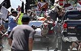 In this August 12, 2017, file photo, people fly into the air as a vehicle is driven into a group of protesters demonstrating against a white nationalist rally in Charlottesville, United States. (Ryan M. Kelly/The Daily Progress via AP, File)