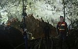 Thai police guard the entrance to a cave complex where 12 boys and their soccer coach went missing, in Mae Sai, Chiang Rai province, in northern Thailand, July 1, 2018. (AP Photo/Sakchai Lalit)