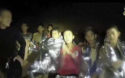 In this July 3, 2018, image taken from video provided by the Thai Navy Seal, Thai boys are with Navy SEALs inside the cave, Mae Sai, northern Thailand. (Thai Navy Seal via AP)