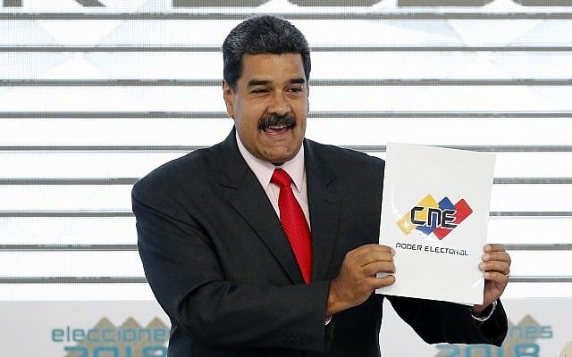 In this May 22, 2018, photo, Venezuela's President Nicolas Maduro holds up the National Electoral Council certificate declaring him the winner of the presidential election, during a ceremony at CNE headquarters in Caracas, Venezuela. (AP Photo/Ariana Cubillos) In this May 22, 2018, photo, Venezuela's President Nicolas Maduro holds up the National Electoral Council certificate declaring him the winner of the presidential election, during a ceremony at CNE headquarters in Caracas, Venezuela. (AP Photo/Ariana Cubillos)