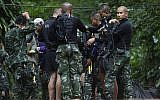 Rescuers prepare dive gear at the entrance to a cave complex in which 12 boys and their soccer coach are trapped in Mae Sai, Chiang Rai province, in northern Thailand, July 4, 2018.  (AP Photo/Sakchai Lalit)