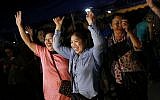 People celebrate after divers evacuated some of the 12 boys and their coach who were trapped at Tham Luang cave in the Mae Sai district of Chiang Rai province, northern Thailand, July 10, 2018. (AP Photo/Sakchai Lalit)