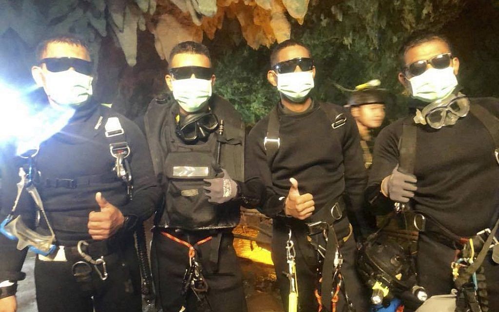 In this undated photo released by Royal Thai Navy on Tuesday, July 10, 2018 show the last four Thai Navy SEALs come out safely after completing the rescued mission inside a cave where 12 boys and their soccer coach have been trapped since June 23, in Mae Sai, Chiang Rai province, northern Thailand. (Royal Thai Navy via AP)