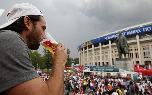 A man drinks a beer in a Budweiser pavilion in front of the Lenin statue and the Luzhniki Stadium as fans arrive for the semifinal match between Croatia and England, during the 2018 soccer World Cup in Moscow, Russia, July 11, 2018 . (Rebecca Blackwell/AP) A man drinks a beer in a Budweiser pavilion in front of the Lenin statue and the Luzhniki Stadium as fans arrive for the semifinal match between Croatia and England, during the 2018 soccer World Cup in Moscow, Russia, July 11, 2018 . (Rebecca Blackwell/AP)