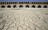In this Tuesday, July 10, 2018 photo, the Zayandeh Roud river no longer runs under the 400-year-old Si-o-seh Pol bridge, named for its 33 arches, in Isfahan, Iran. (AP Photo/Vahid Salemi)