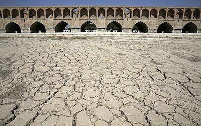 In this Tuesday, July 10, 2018 photo, the Zayandeh Roud river no longer runs under the 400-year-old Si-o-seh Pol bridge, named for its 33 arches, in Isfahan, Iran. (AP Photo/Vahid Salemi)