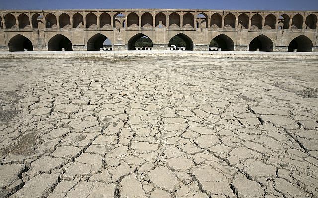 In this Tuesday, July 10, 2018 photo, the Zayandeh Roud river no longer runs under the 400-year-old Si-o-seh Pol bridge, named for its 33 arches, in Isfahan, Iran. (AP Photo/Vahid Salemi)