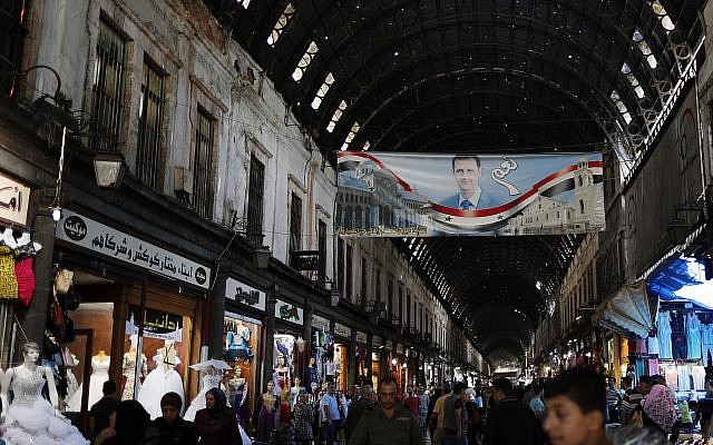 A poster of President Bashar Assad with Arabic that read, "Yes," hangs on the Hamadiyah market, or souk in Arabic, that was named after the 34th Sultan of the Ottoman Empire Abdul Hamid II, in the Old City of Damascus, Syria, July 19, 2018. (Hassan Ammar/AP)