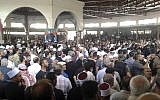 In this photo released by the Syrian official news agency SANA, mourners from the Druze community attend a mass funeral of people killed a day earlier by a series of suicide bombings launched by the Islamic State's fighters on the eastern and northern countryside of the southern province of al-Sweida, Syria, on July 26, 2018. (SANA via AP)