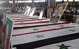 In this photo released by the Syrian official news agency SANA, mourners from the Druze community attend a mass funeral of people killed a day earlier by a series of suicide bombings launched by the Islamic State's fighters on the eastern and northern countryside of the southern province of al-Sweida, Syria, on July 26, 2018. (SANA via AP)
