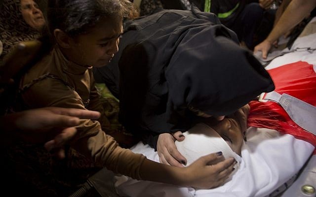 Palestinian relatives of 12 year-old boy, Majdi al-Satari, who was shot and killed by Israeli troops on Friday's ongoing protest at the Gaza Strip's border with Israel, mourn over his body at the family home during his funeral in town of Rafah, Southern Gaza Strip on July 28, 2018. (AP Photo/Khalil Hamra) Palestinian relatives of 12 year-old boy, Majdi al-Satari, who was shot and killed by Israeli troops on Friday's ongoing protest at the Gaza Strip's border with Israel, mourn over his body at the family home during his funeral in town of Rafah, Southern Gaza Strip on July 28, 2018. (AP Photo/Khalil Hamra)