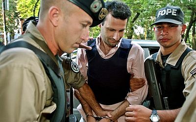 Lebanese citizen Assad Ahmad Barakat, (c), arrives at a courthouse in Asuncion, Paraguay, November 17, 2003. (AP Photo/Jorge Saenz)