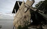 Illustrative image of s local house damaged by floods in Laos in 2011. (AP Photo/Heng Sinith)
