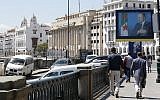 Illustrative: Algerians walk past a portrait of Algerian President Abdelaziz Bouteflika in the capital Algiers on May 2, 2017. (AP Photo/Toufik Doudou)