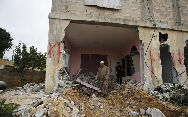 File: A Palestinian inspects the family house of Omar Al-Abed after it was demolished by Israeli authorities in the West Bank village of Kobar, near Ramallah, Aug. 16, 2017. Al-Abed stabbed to death three Jewish residents of a nearby settlement in July 2017. (AP Photo/Nasser Shiyoukhi) File: A Palestinian inspects the family house of Omar Al-Abed after it was demolished by Israeli authorities in the West Bank village of Kobar, near Ramallah, Aug. 16, 2017. Al-Abed stabbed to death three Jewish residents of a nearby settlement in July 2017. (AP Photo/Nasser Shiyoukhi)