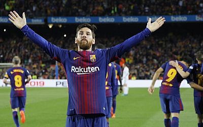 Barcelona's Lionel Messi greets fans after scoring his side's second goal during a Spanish La Liga soccer match between Barcelona and Real Madrid, dubbed 'El Clasico', at the Camp Nou stadium in Barcelona, Spain, May 6, 2018. (AP Photo/Emilio Morenatti)
