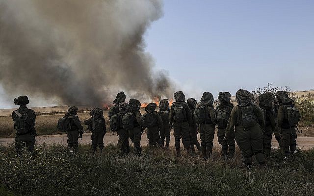 Illustrative: Israeli soldiers watch a wheat field that caught fire next to kibbutz Nahal Oz along the Israel-Gaza border, May 14, 2018 (AP Photo/Tsafrir Abayov) Illustrative: Israeli soldiers watch a wheat field that caught fire next to kibbutz Nahal Oz along the Israel-Gaza border, May 14, 2018 (AP Photo/Tsafrir Abayov)