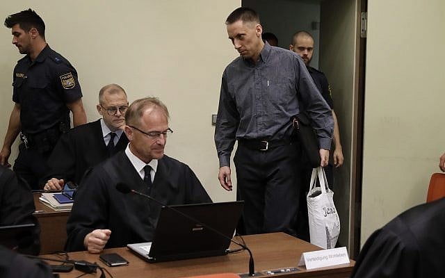 Defendant Ralf Wohlleben, center with white bag, arrives for his trial in the court room in Munich, Germany, June 5, 2018. (AP Photo/Matthias Schrader, Pool) Defendant Ralf Wohlleben, center with white bag, arrives for his trial in the court room in Munich, Germany, June 5, 2018. (AP Photo/Matthias Schrader, Pool)