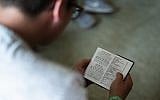 Illustrative photo of a Jewish man reading from a prayer book. (AP Photo/Markus Schreiber)