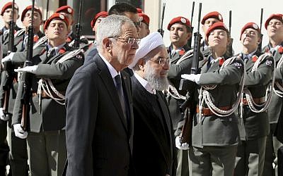 Austrian President Alexander Van Der Bellen, left, and Iranian President Hassan Rouhani attend a military welcome ceremony in Vienna, Austria, Wednesday, July 4, 2018 (AP Photo/Ronald Zak)