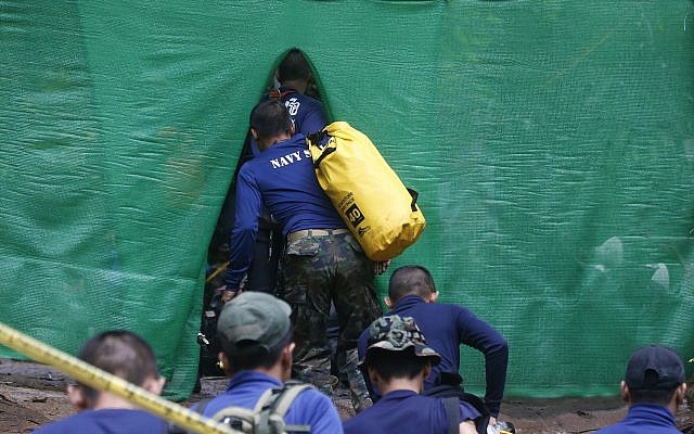 Rescuers arrive near the cave where 12 boys and their soccer coach have been trapped since June 23, in Mae Sai, Chiang Rai province, in northern Thailand Sunday, July 8, 2018. (AP Photo/Sakchai Lalit) Rescuers arrive near the cave where 12 boys and their soccer coach have been trapped since June 23, in Mae Sai, Chiang Rai province, in northern Thailand Sunday, July 8, 2018. (AP Photo/Sakchai Lalit)