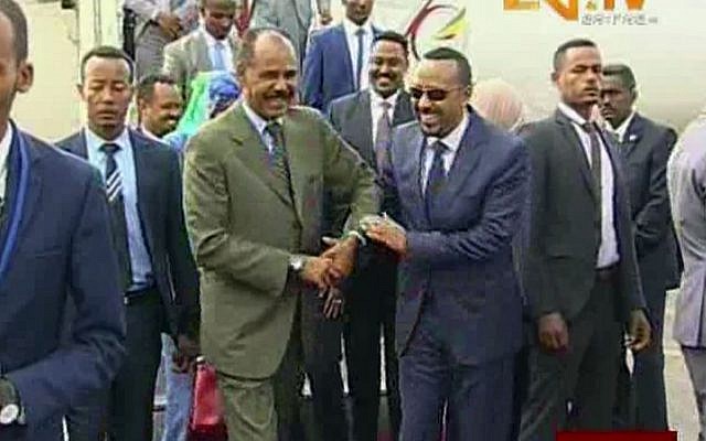 In this grab taken from video provided by ERITV, Ethiopia's Prime Minister Abiy Ahmed, center right, is welcomed by Erirea's President Isaias Afwerki as he disembarks the plane, in Asmara, Eritrea, July 8, 2018. (ERITV via AP) In this grab taken from video provided by ERITV, Ethiopia's Prime Minister Abiy Ahmed, center right, is welcomed by Erirea's President Isaias Afwerki as he disembarks the plane, in Asmara, Eritrea, July 8, 2018. (ERITV via AP)