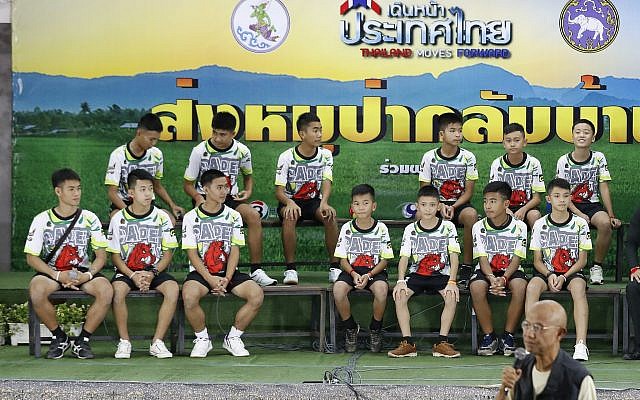 Members of the rescued soccer team and their coach sit during a press conference discussing their ordeal in the cave in Chiang Rai, northern Thailand, July 18, 2018 (AP Photo/Vincent Thian) Members of the rescued soccer team and their coach sit during a press conference discussing their ordeal in the cave in Chiang Rai, northern Thailand, July 18, 2018 (AP Photo/Vincent Thian)