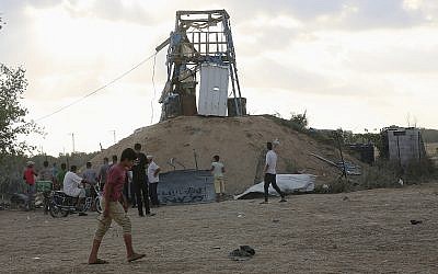 Palestinians inspect a military observation post that was hit by an Israeli tank shell east of Khan Younis, southern Gaza Strip, July 20, 2018 (AP Photo/Adel Hana)