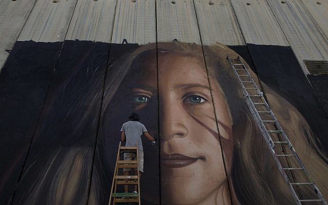 An artist paints a giant mural of prominent Palestinian activist Ahed Tamimi on part of the Israeli security barrier, in the West Bank city of Bethlehem on July 25, 2018. (AP Photo/Nasser Nasser) An artist paints a giant mural of prominent Palestinian activist Ahed Tamimi on part of the Israeli security barrier, in the West Bank city of Bethlehem on July 25, 2018. (AP Photo/Nasser Nasser)