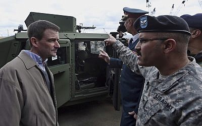 Then US Ambassador to Lebanon David Hale, left, speaks with a US Army soldier during a handover ceremony of US weapons to the Lebanese army at Beirut's port in Lebanon on Sunday, Feb. 8, 2015. (AP Photo/Bilal Hussein)