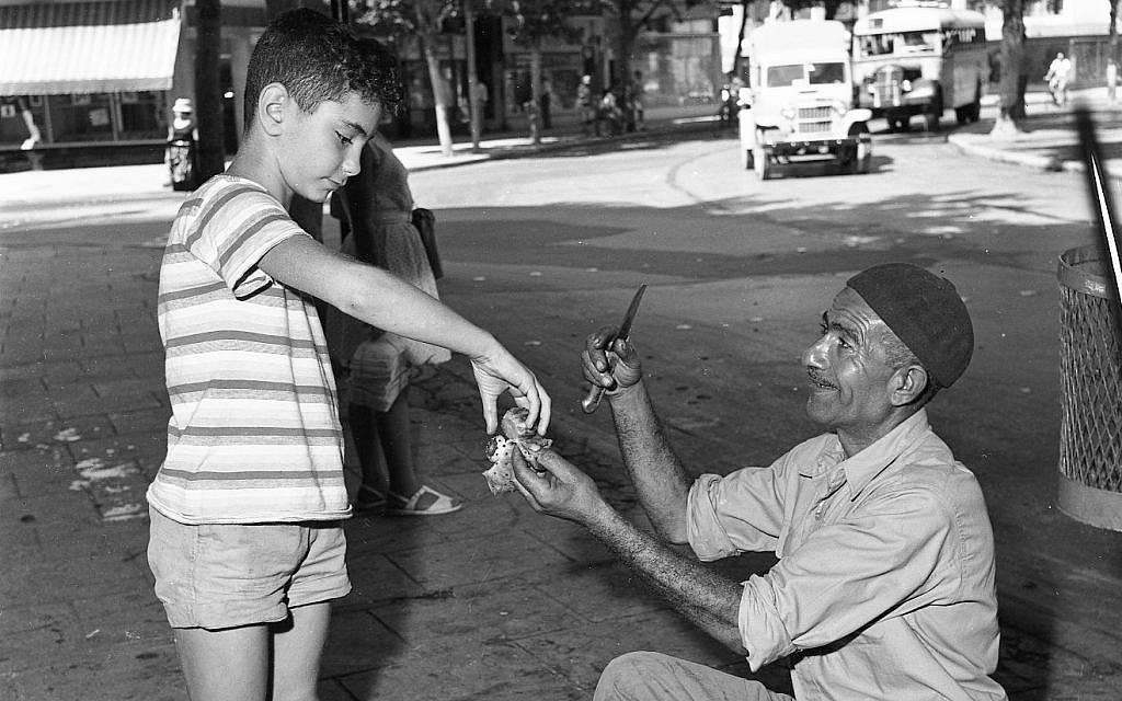 A man selling sabras on the street in the 1950s. (Efraim Ilani)