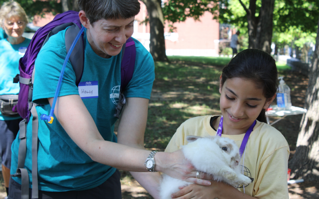 A camper and a counselor sharing a happy moment at a summer camp for refugee children run by the St. Louis Jewish Community Relations Council and the International Institute of St. Louis, an immigrant integration service, July 2018. (Courtesy of St. Louis JCRC/via JTA) A camper and a counselor sharing a happy moment at a summer camp for refugee children run by the St. Louis Jewish Community Relations Council and the International Institute of St. Louis, an immigrant integration service, July 2018. (Courtesy of St. Louis JCRC/via JTA)